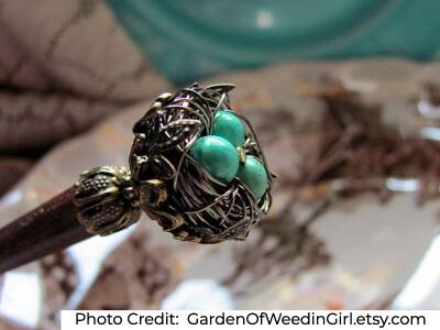 wooden hair stick with blue robin's nest on the end